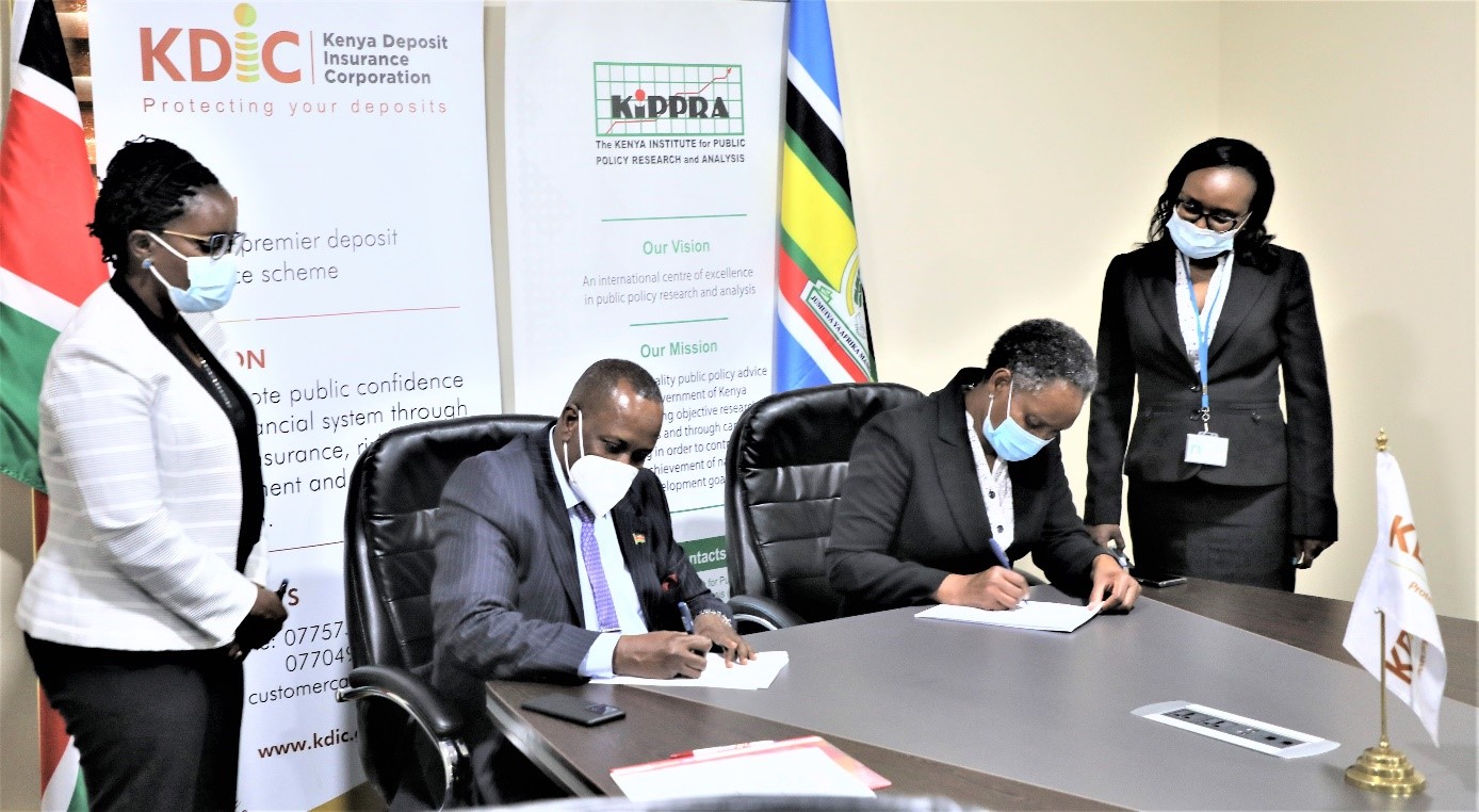 To a greater partnership....KDIC CEO Mr. Mohamud A. Mohamud & KIPPRA Exec. Director. Dr. Rose Ngugi put pen to paper during the signing of a collaborative MOU on empirical research between the two institutions. Looking on are KDIC’s Eunice Kitche,  Head of Legal (Left) and Caroline Mukiira, (Right)  Ag. Corporation Secretary, KIPPRA